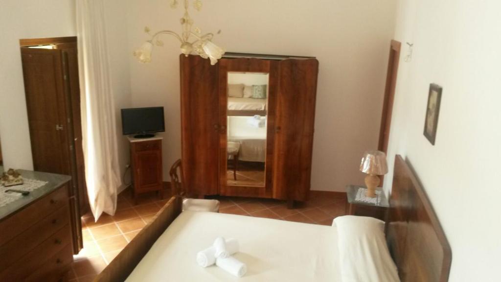 a bedroom with a mirror and a bed in a room at da Ciccio e Concy in Tursi