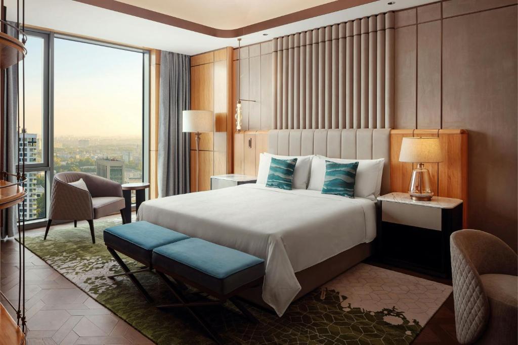 a hotel room with a bed and a large window at JW Marriott Hotel Tashkent in Tashkent