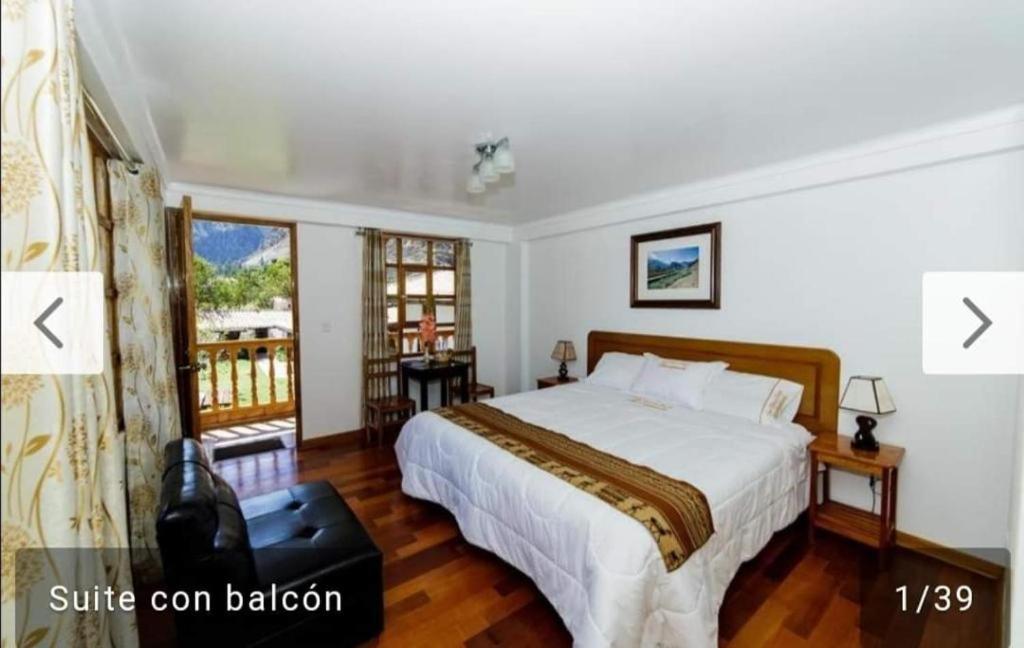 a bedroom with a large bed and a balcony at Casablanca Ollantaytambo Museo & Spa in Ollantaytambo