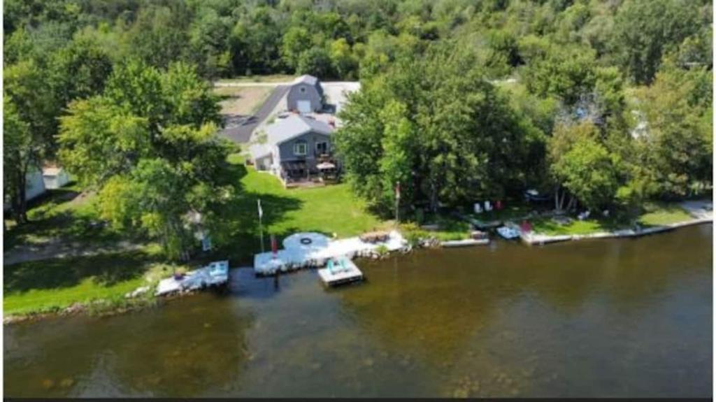 an aerial view of a house with a boat in the water at Riverview Cottage Escape in Frankford