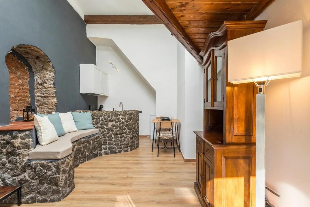 a living room with a couch and a table at Gesuiti Home - Lumina Collection in Catania