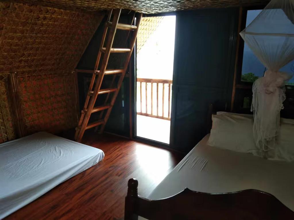 Ένα ή περισσότερα κρεβάτια σε δωμάτιο στο Villa Loyola Resthouse