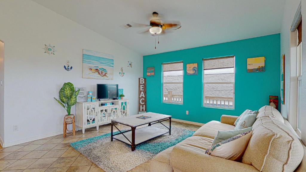 a living room with a couch and a table at Casa Siwichi in Crystal Beach