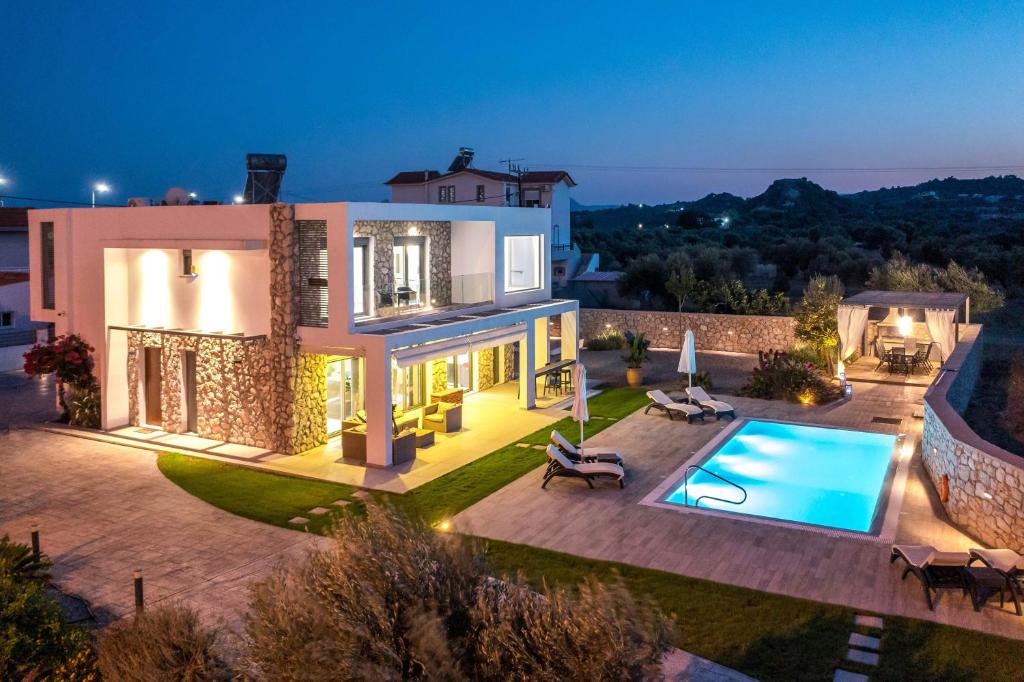 an aerial view of a villa with a swimming pool at Modern Villa with Pool & Garden Kastalys, Rhodes in Kalithies