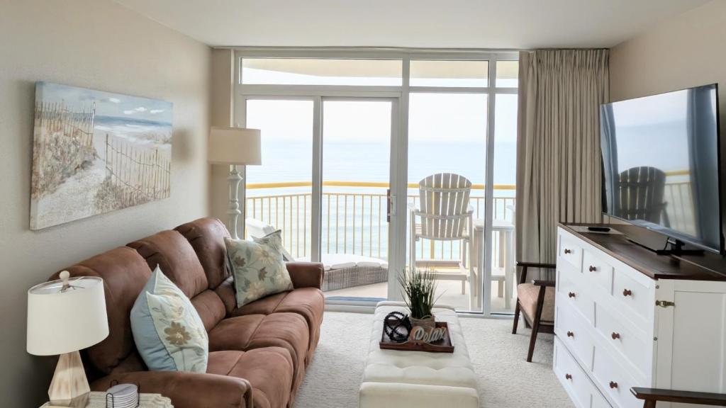 a living room with a couch and a television at Beautiful Beachfront 2BR2Bath & 2 Balconies in North Myrtle Beach