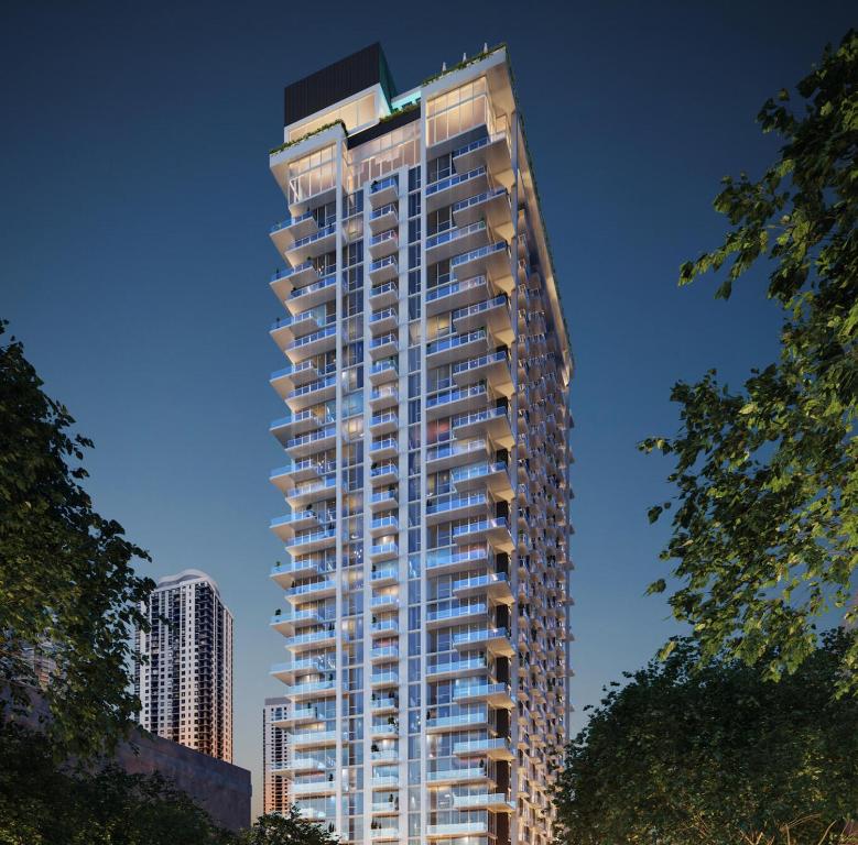 a tall apartment building with a lot of windows at Crosby Miami World Center in Miami