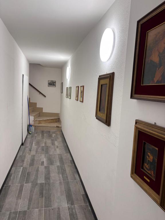 a hallway with paintings and pictures on the walls at Il borgo in Barge