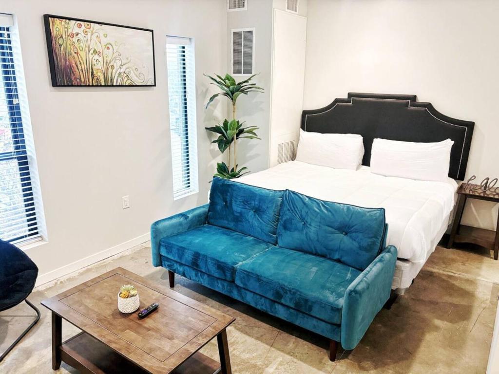 a bedroom with a bed and a blue couch at Indigo Studio in Des Moines