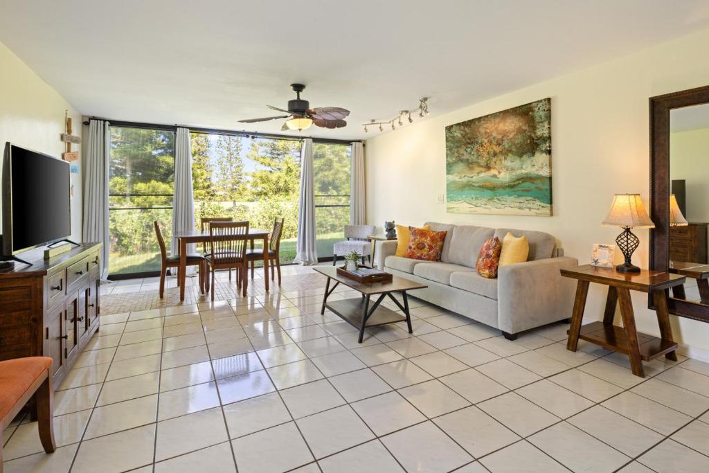 a living room with a couch and a table at The Beach Nook at Turtle Bay in Kahuku