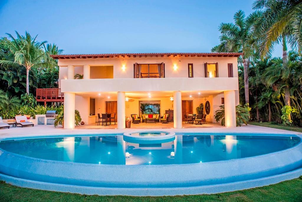 a house with a large swimming pool in front of it at Ocean view villa- home Infinity Pool Concierge in Punta Mita