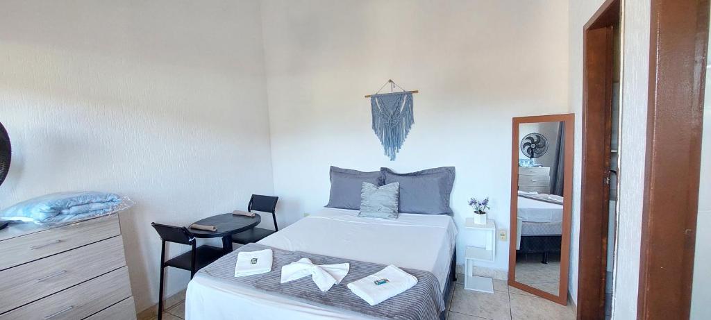 una piccola camera da letto con un letto e uno specchio di Quitinete pé na praia Ap 201 a Rio das Ostras