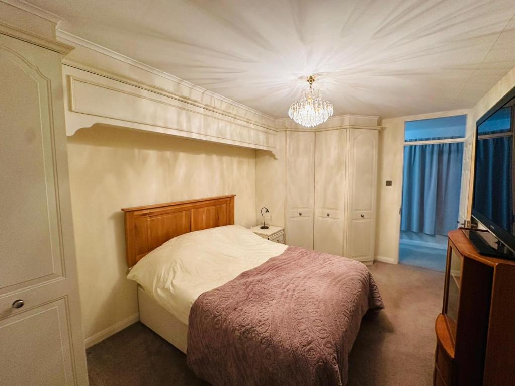 a bedroom with a bed and a television in it at Randall Farm in Fawkham