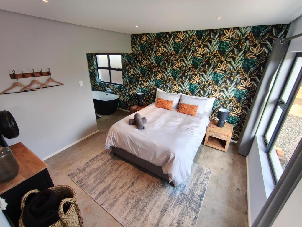 a bedroom with a bed and a wall mural at Beautiful Breakaway in Champagne Valley