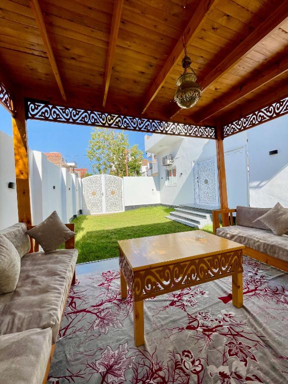 a living room with a couch and a table at Quiet Villa in Luxor