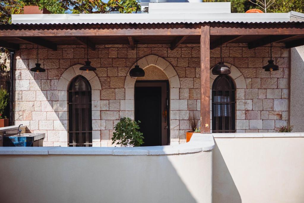 a brick house with a black door at City of David - Boutique Stay by the Western Wall in Jerusalem