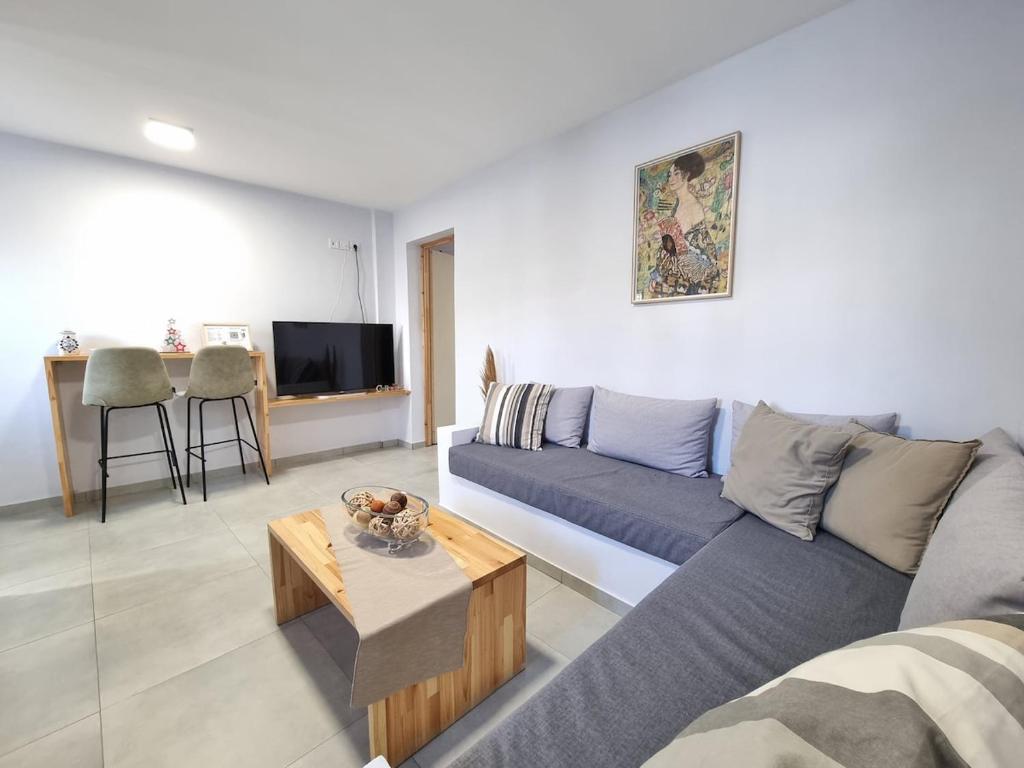 a living room with a couch and a table at Aeolus Apartment I in Galaxidhion