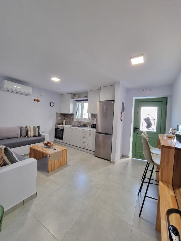 a kitchen and living room with a couch and a table at Aeolus Apartment I in Galaxidi