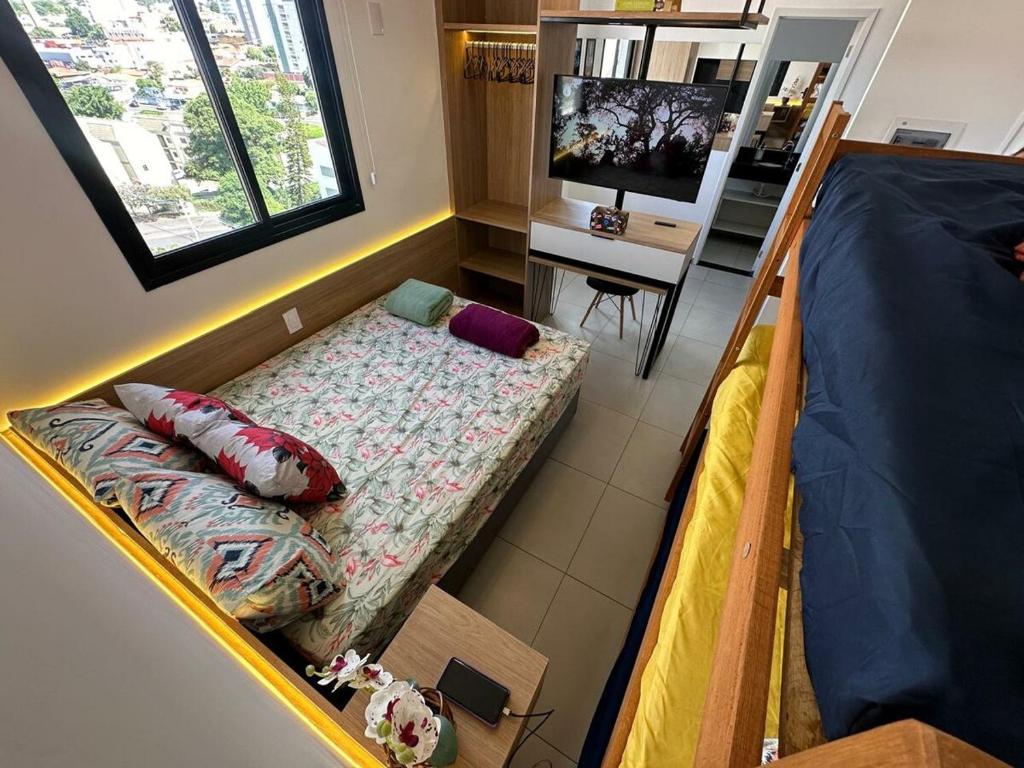 a room with a bed and a couch and a desk at TESLA APT2-Pool, Air, gym, 24-hour portaria in São Carlos