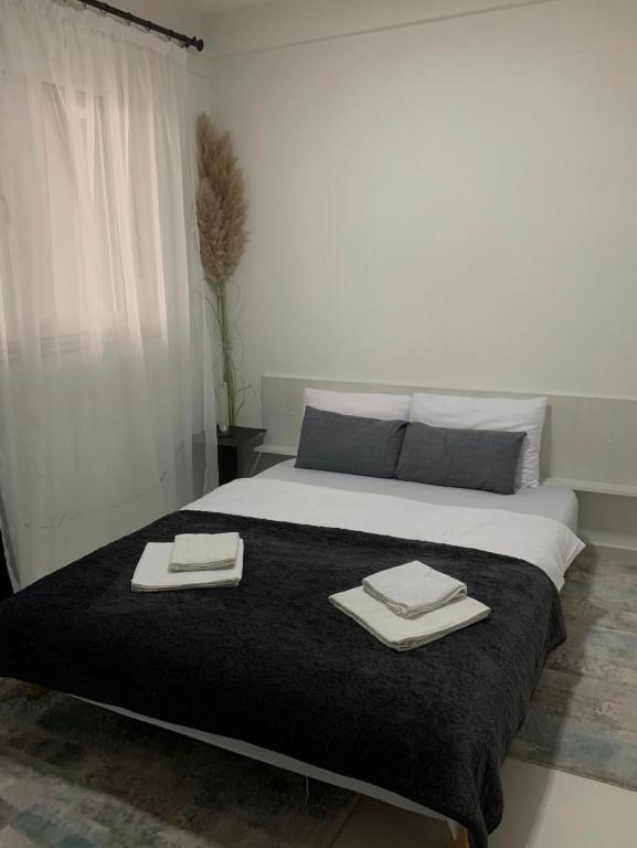 a bedroom with a bed with two towels on it at Aura in Kumanovo