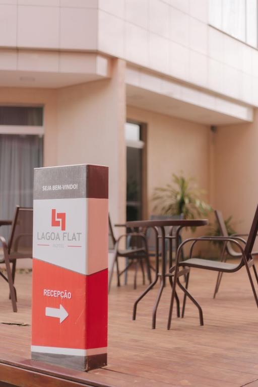 a box sitting on a table with tables and chairs at Lagoa Flat Hotel in Lagoa da Prata