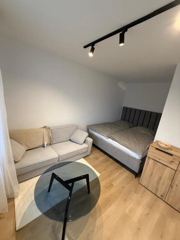 a living room with a couch and a table at Ďumbierska Sásová Apartment in Otilia