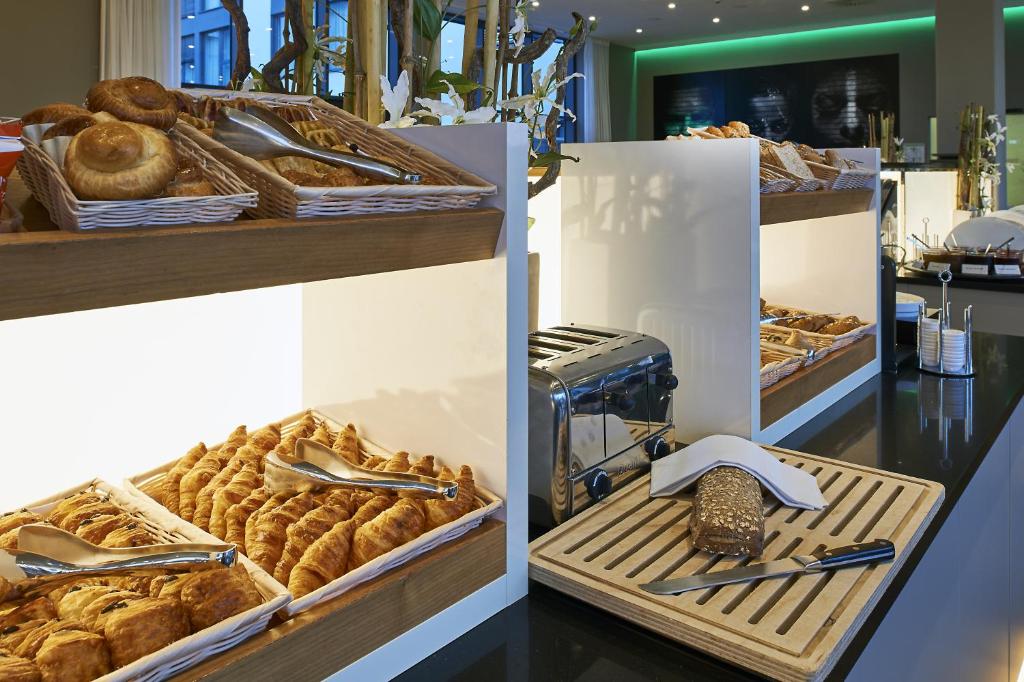 a bakery with several baskets of pastries on display at LÉGÈRE HOTEL Luxembourg in Luxembourg