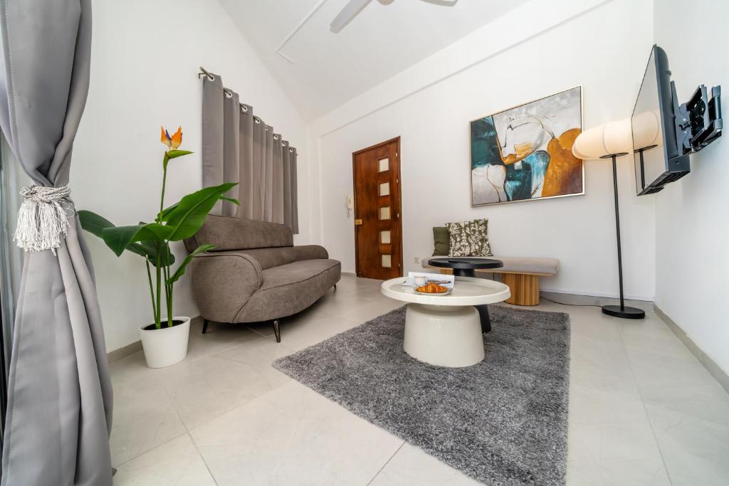 a living room with a table and a chair at Central 2 bedroom flat in Nicosia