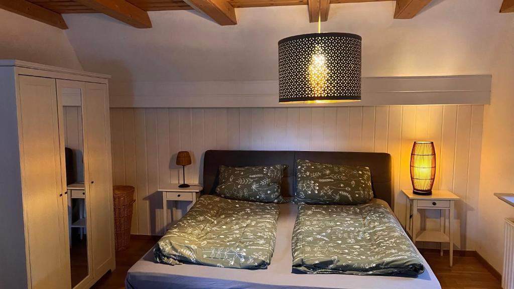 a bedroom with a bed with a lamp and two tables at Schöne Ferienwohnungen -bis zu 4 Personen 70qm2- in Oldenburg Eversten in Oldenburg