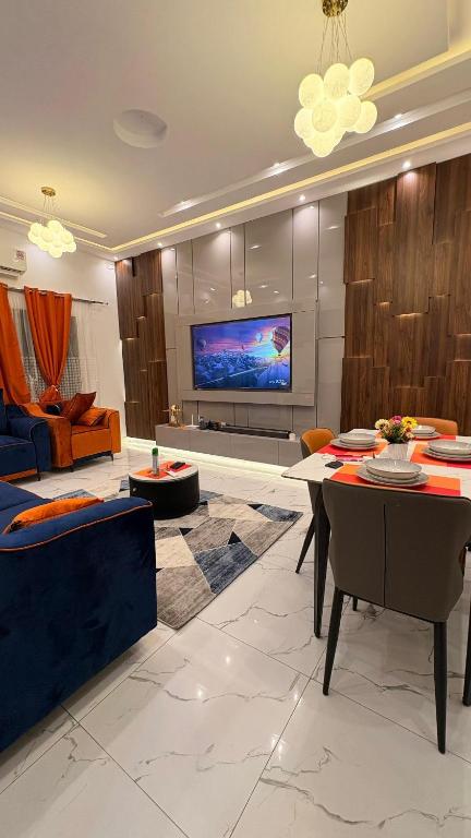 a living room with a table and a tv at Best place appartement in Cotonou