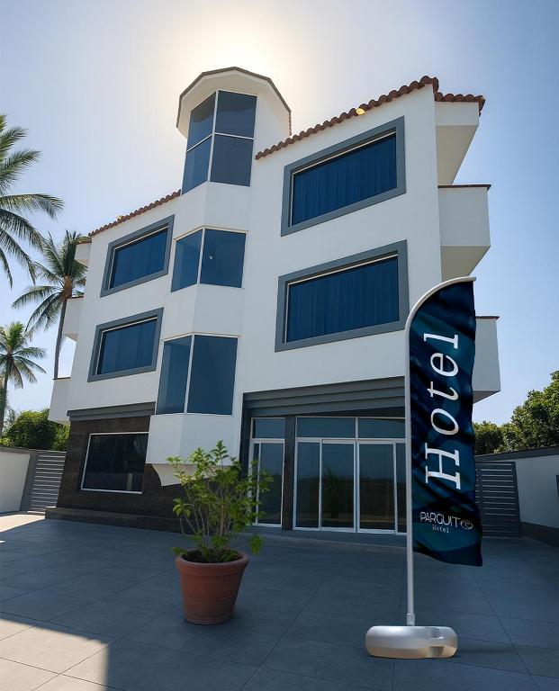 a building with a sign in front of it at Hotel Parguito in La Sabana