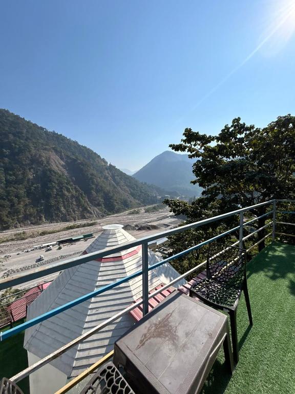 a balcony with a bench and a view of a river at LA Foresta resort by Utopia in Shivpuri
