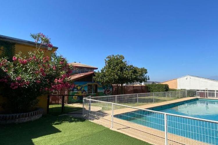 uma piscina com uma cerca ao lado de uma casa em Tierras del Sol em Quilpué