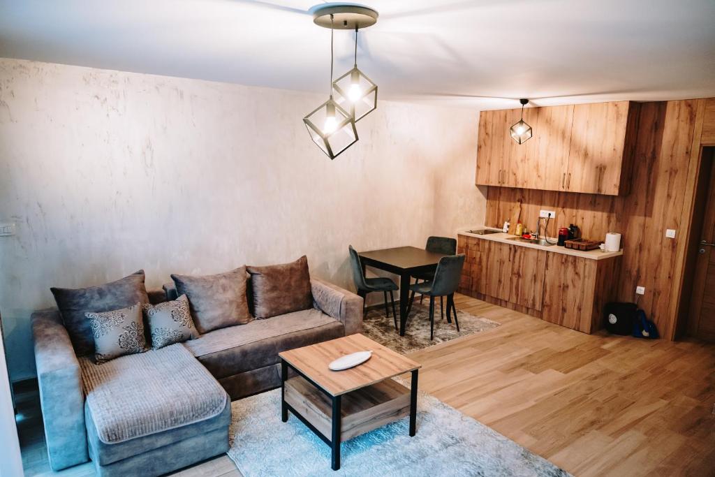 una sala de estar con un sofá y una mesa en VM Apartments Zabljak, en Razvršje