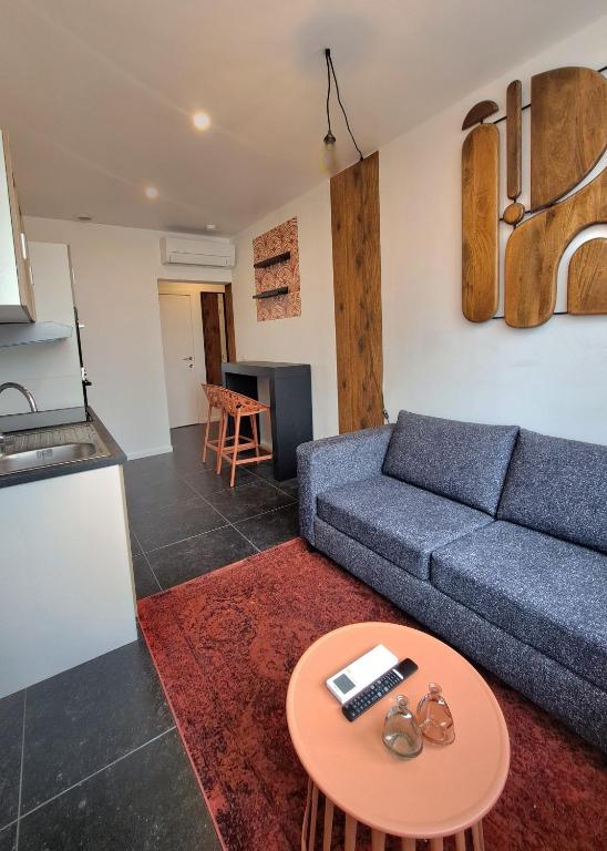 a living room with a couch and a table at L'Escapade Tournaisienne in Tournai