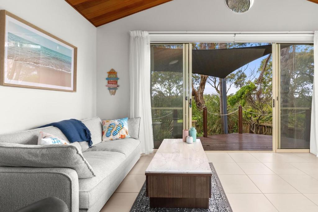 a living room with a couch and a table at Sails One - Inverloch in Inverloch