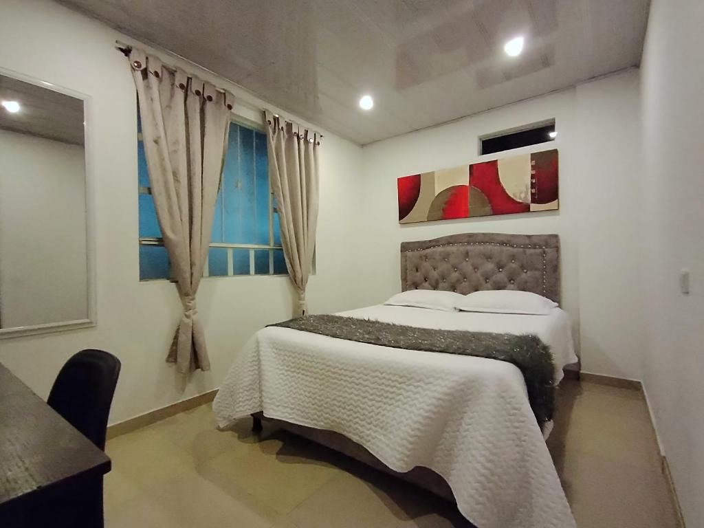 um quarto com uma cama e uma janela em C habitación con baño privado em Bogotá