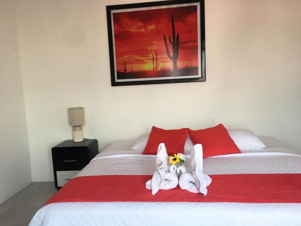 a bedroom with a bed with towel animals on it at Piqueros patas azules in Puerto Villamil