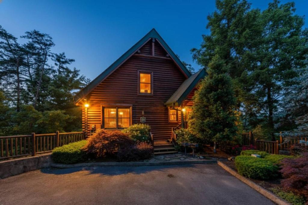 a wooden house with lights on the front of it at Mountain Creek Lodge in Pigeon Forge