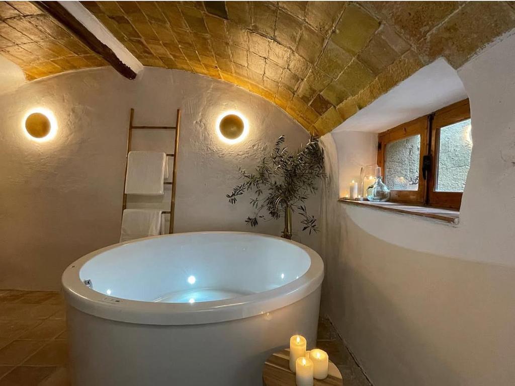 a bathroom with a tub with candles in it at Halona Casa Rural in Bullas