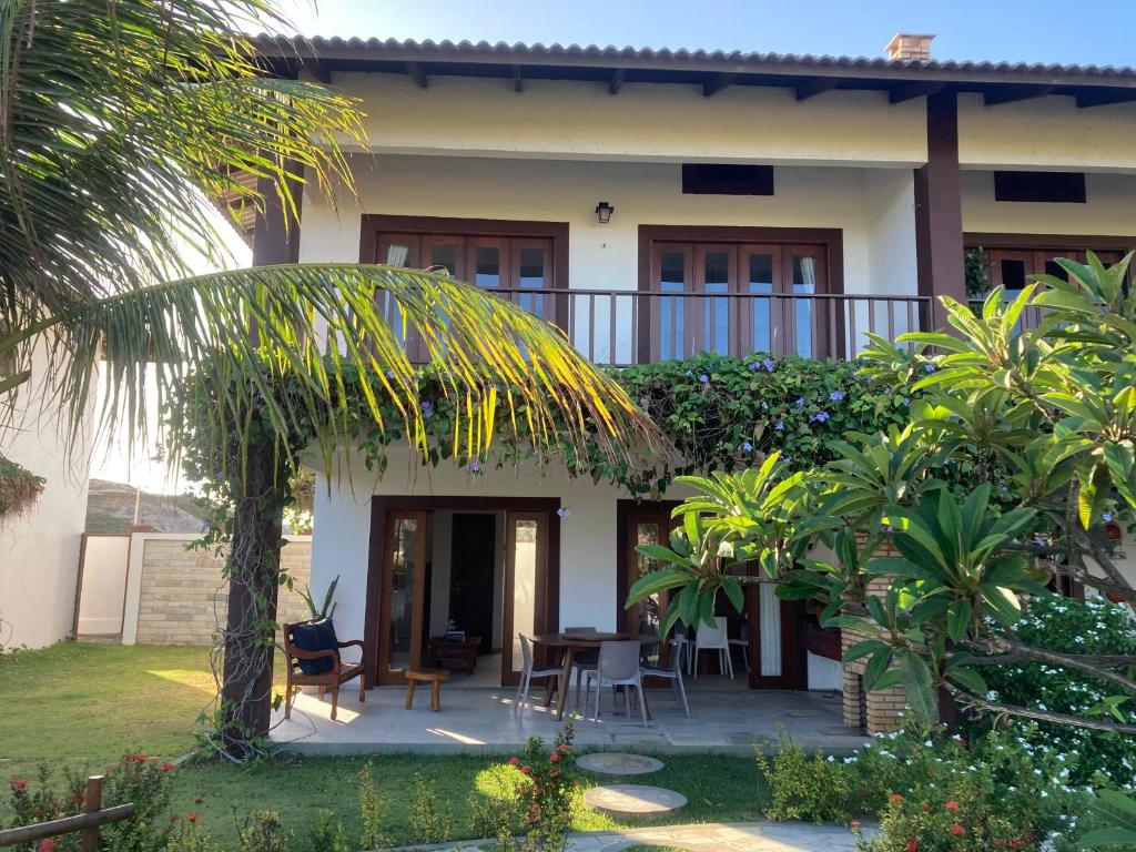 una casa con patio, tavolo e sedie di Casa encanto dos corais a Trairi
