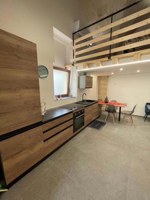 梅萨涅Suite La Madonnina的一个带木制橱柜和桌子的厨房