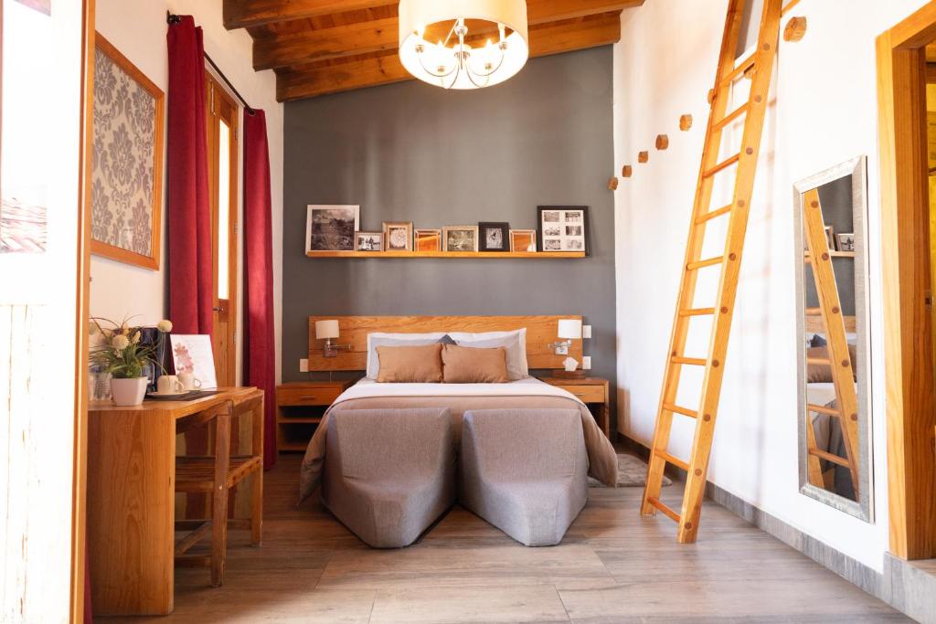 a bedroom with a bed and a ladder in it at Hotel bugambilias in Valle de Bravo