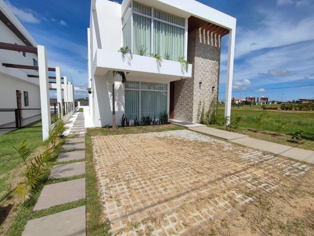 a house with a stone walkway in front of it at Arena cielo y Mar in Naranjalito