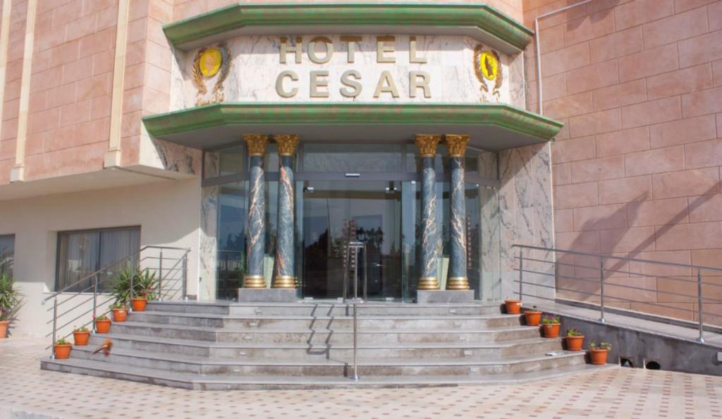 a hotel entrance with stairs in front of a building at Hôtel César Palace in Sousse