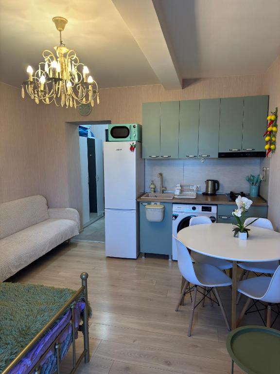a kitchen with a white refrigerator and a table at თბილისი in Bakuriani