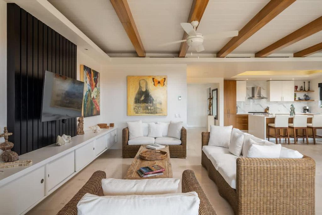 a living room with a couch and a tv at Luxury- HDM Condo Concierge Golf Cart in Punta Mita