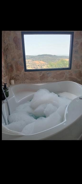 a bath tub filled with lots of bubbles at Casa Rural Abuela Remedios in Segura de León