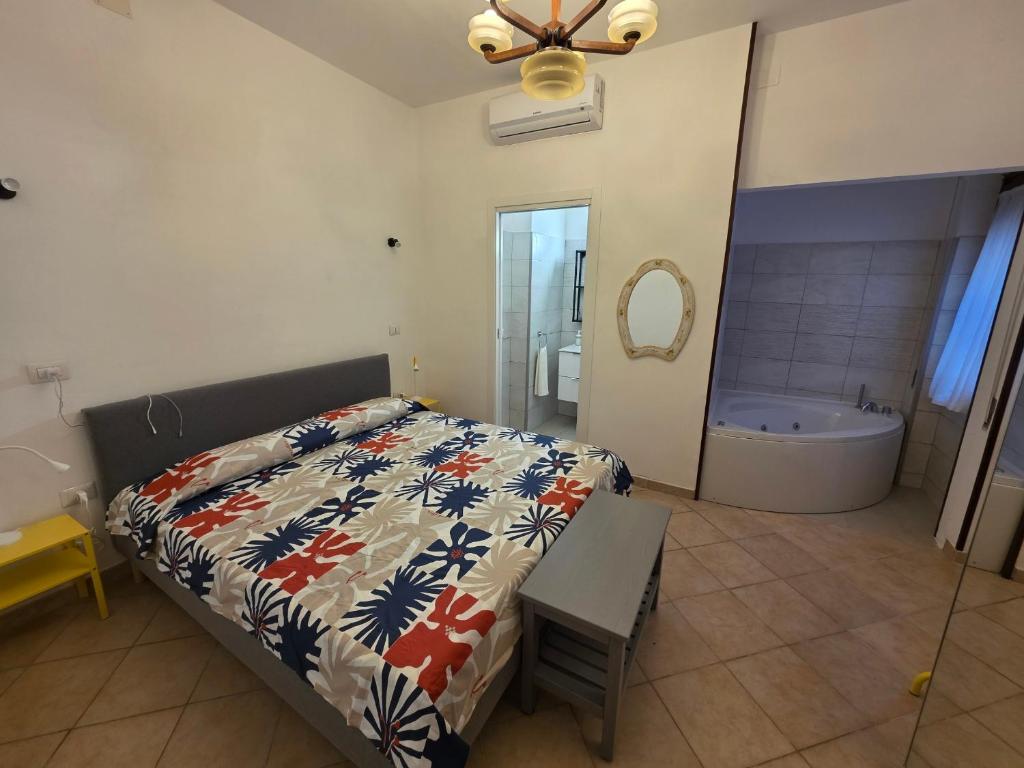 a bedroom with a bed and a bath tub at Alloggio turistico di Stefano in Lido di Ostia
