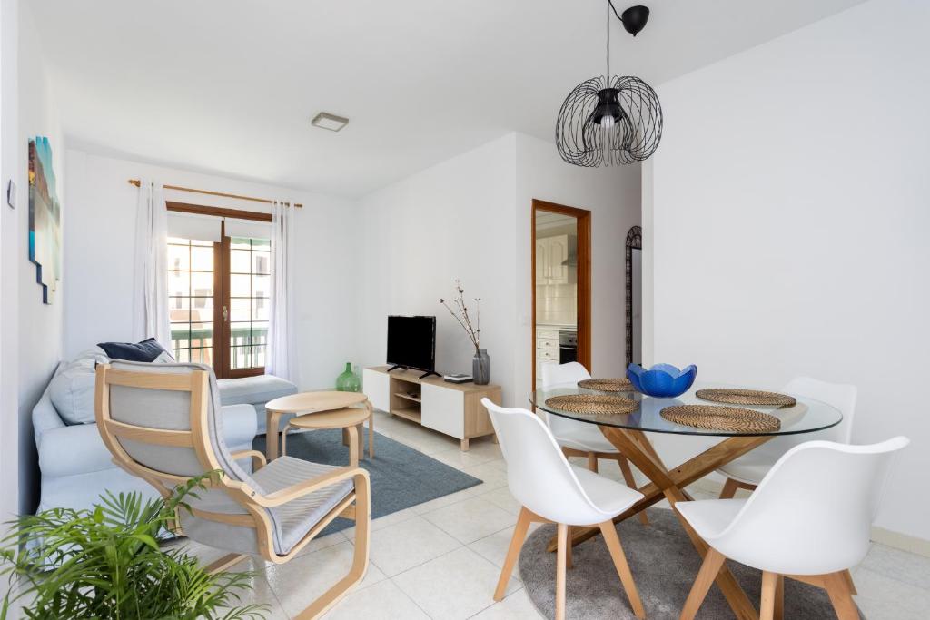 a living room with a table and chairs at Atlantic & Teide Views Penthouse in Puerto de la Cruz