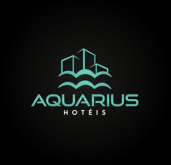 a logo for a hotel with buildings in the clouds at Aquarius Hoteis Ltda in Canarana